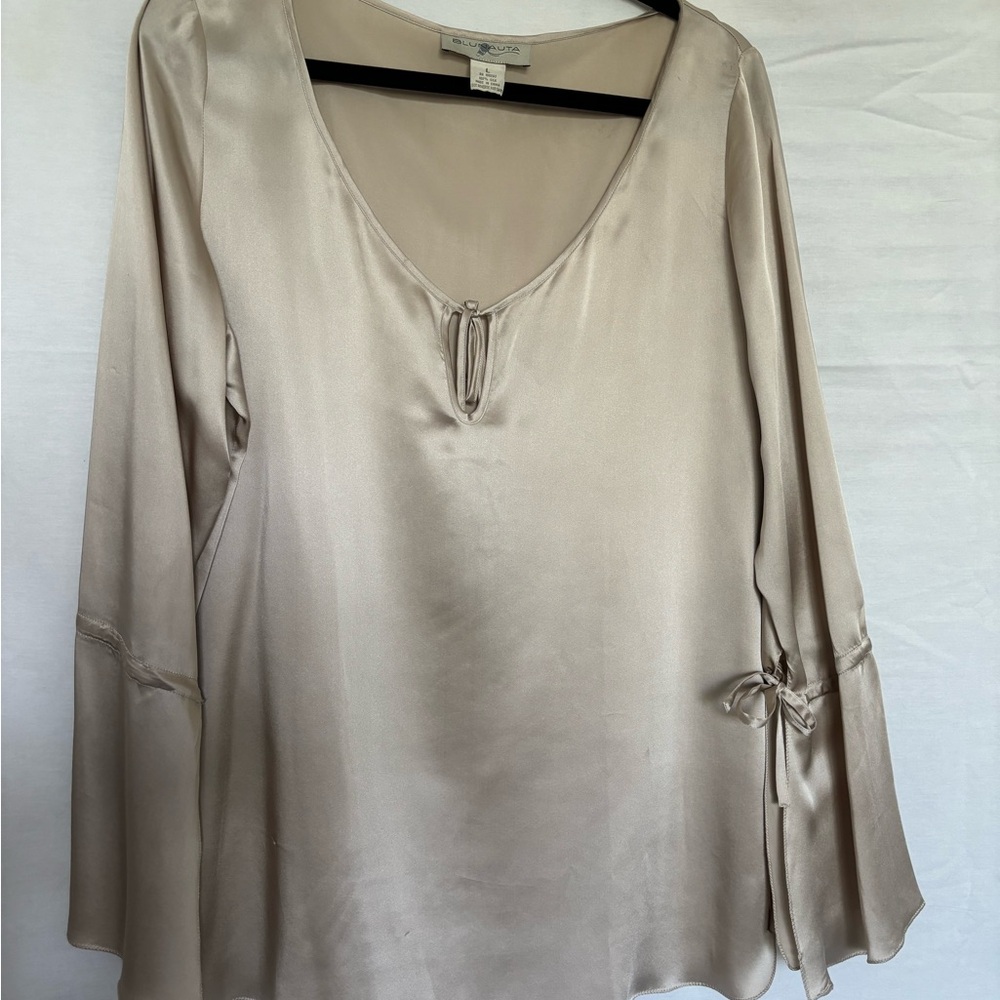 100% silk blouse, bell sleeves with a split and a tie.  Beautiful cream color.